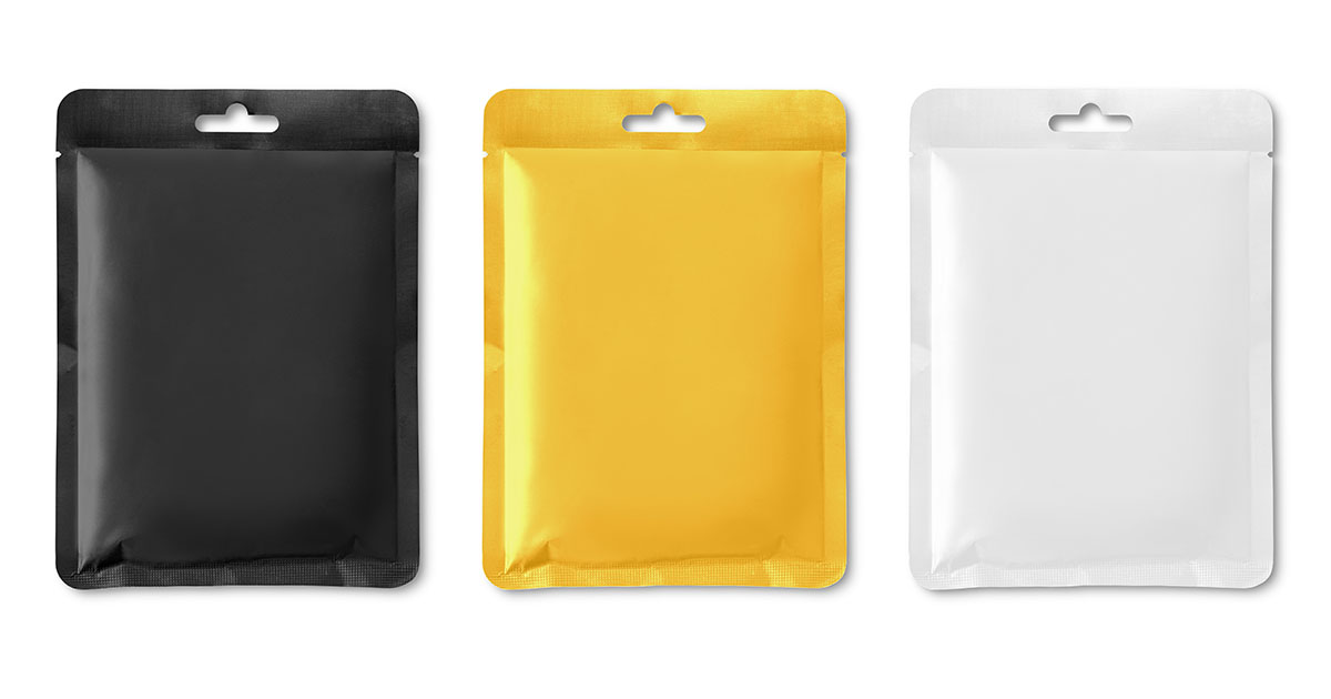 Three blank flexible pouches in black, yellow and white