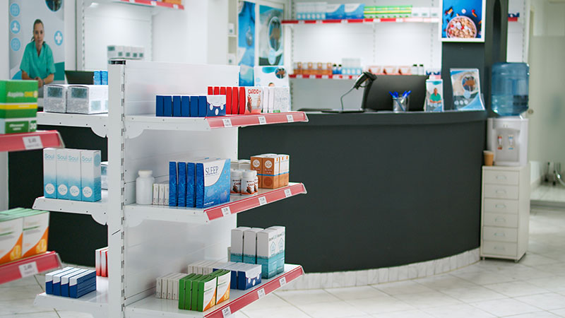 Pharmacy retail counter with packaged products on shelves