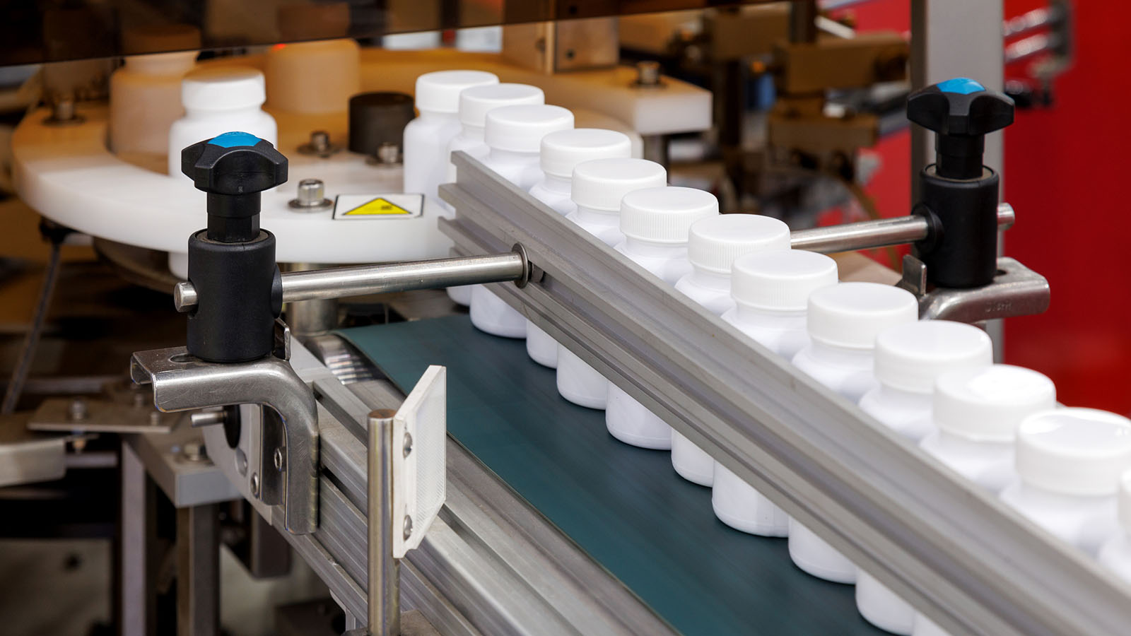 Contract packer labeling line running white HDPE bottles