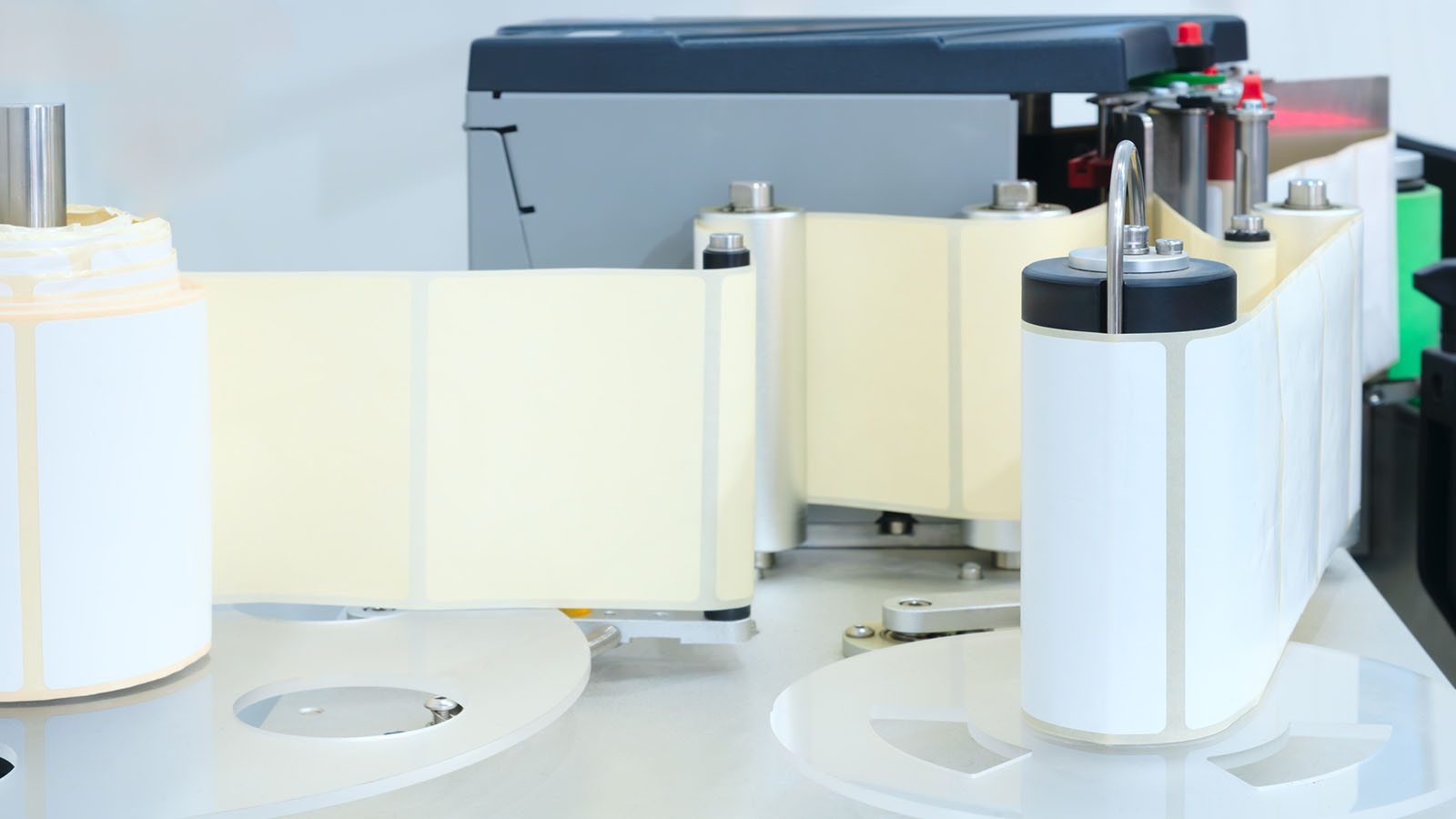 Blank pressure sensitive label rolls loaded on an applicator