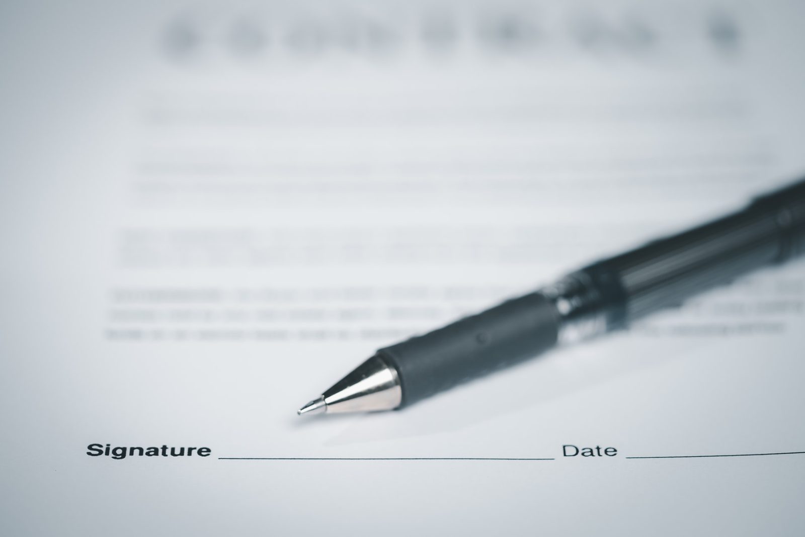 A pen resting on a signed supply agreement, close up on the contract page