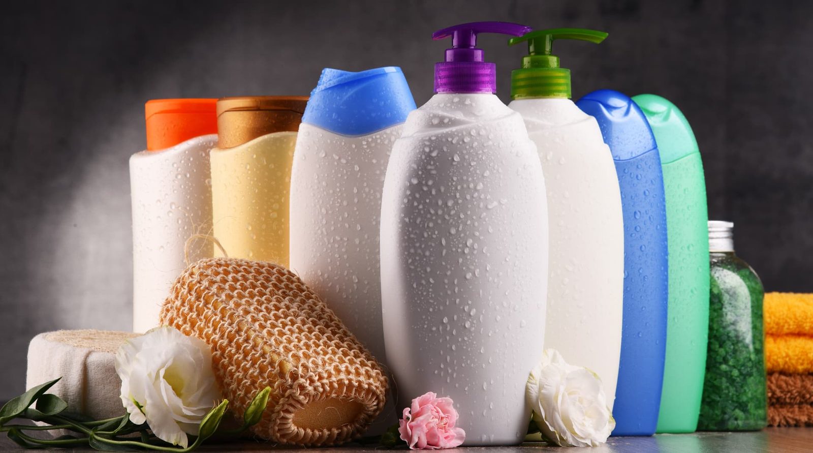 A group of plastic body care and beauty product bottles