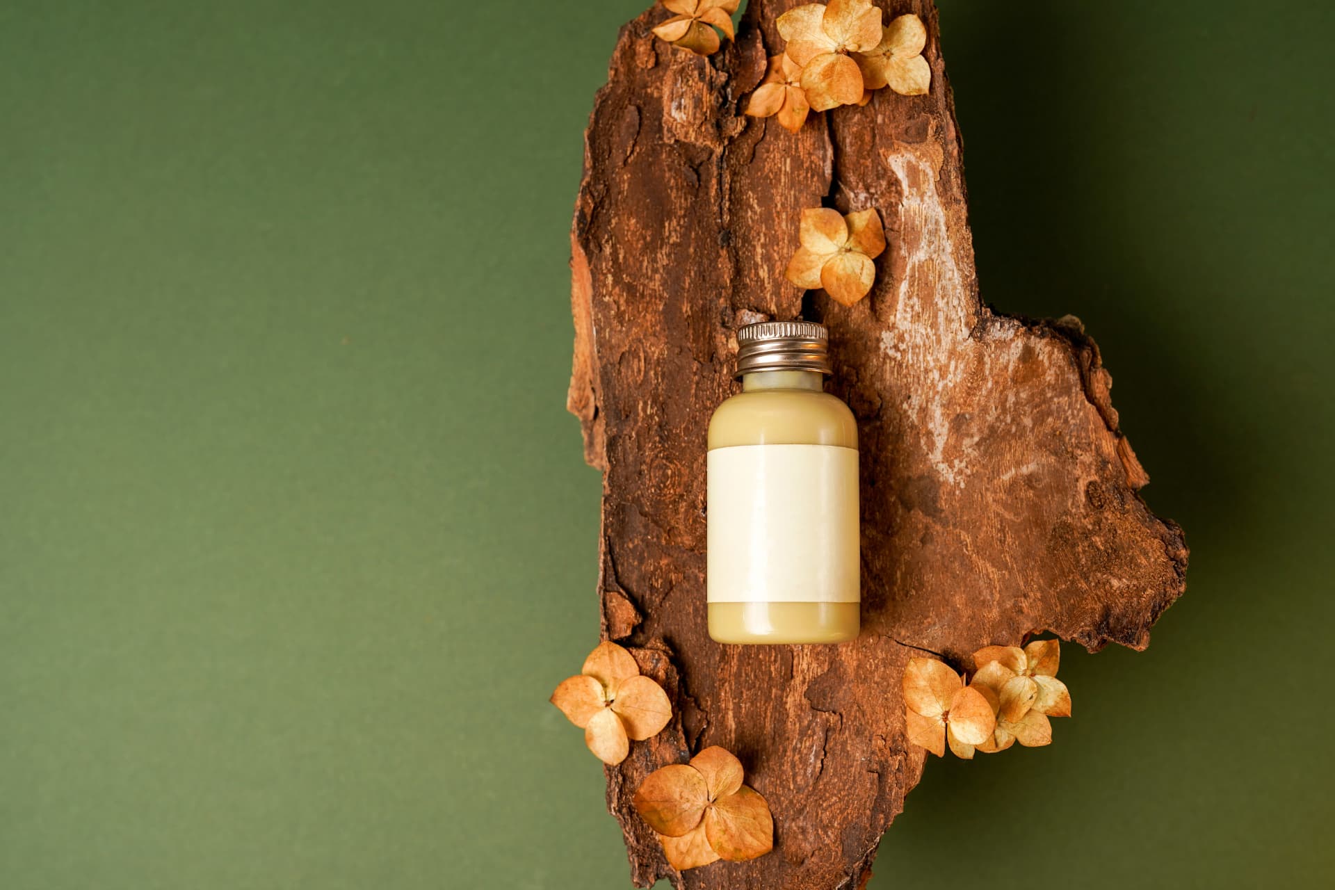 Amber cosmetic bottle with a plain white label on a wooden surface